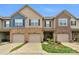 Townhomes with brick facades and attached garages offer a blend of modern design and classic appeal at 6021 Sweetbay Ln, Indian Land, SC 29707