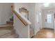 Welcoming foyer with hardwood floors, stairs, and a storage bench at 6021 Sweetbay Ln, Indian Land, SC 29707