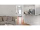 Bright hallway with hardwood floors leading to the front door and kitchen at 6021 Sweetbay Ln, Indian Land, SC 29707