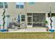Patio with seating area and view of the screened-in porch, with a well-maintained lawn at 6021 Sweetbay Ln, Indian Land, SC 29707
