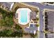 Overhead shot showcasing a community pool with ample parking, landscaping, and bath house at 6021 Sweetbay Ln, Indian Land, SC 29707