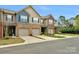 Charming townhomes feature brick accents, single-car garages, and well-maintained landscaping at 6021 Sweetbay Ln, Indian Land, SC 29707