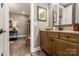 Bathroom vanity with tan countertop and wood cabinets with art and decorative elements at 6026 Gray Shadow Ct, York, SC 29745