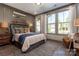 A cozy bedroom boasts natural light, coastal decor and wood plank flooring at 6026 Gray Shadow Ct, York, SC 29745