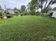 Large grassy backyard with a partial fence and trees, perfect for outdoor activities at 603 E Main St, Rock Hill, SC 29730