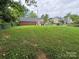 Spacious backyard featuring lush lawn and a partial fence, offering privacy and room to relax at 603 E Main St, Rock Hill, SC 29730