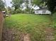 Large backyard featuring an expansive grassy area, partial fence, and mature trees at 603 E Main St, Rock Hill, SC 29730