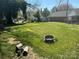 Large backyard with plenty of green space and a fire pit at 603 E Main St, Rock Hill, SC 29730