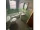 Retro bathroom featuring green tile surround, updated fixtures, and natural light from a window at 603 E Main St, Rock Hill, SC 29730