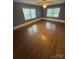 Large bedroom featuring hardwood floors and ample natural light from two windows at 603 E Main St, Rock Hill, SC 29730
