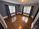 Cozy bedroom featuring hardwood floors, large windows, and curtains for a comfortable space at 603 E Main St, Rock Hill, SC 29730
