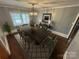 Formal dining room featuring hardwood floors, modern lighting, and seating for six at 603 E Main St, Rock Hill, SC 29730