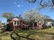 Charming brick home with a well-manicured lawn and a beautiful flowering tree in the front yard at 603 E Main St, Rock Hill, SC 29730