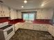 Functional kitchen with white cabinets, red countertops, and ample counter space for cooking at 603 E Main St, Rock Hill, SC 29730