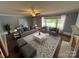 Staged living room with neutral decor, large windows, and classic hardwood floors at 603 E Main St, Rock Hill, SC 29730