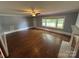 Spacious living room featuring hardwood floors, neutral walls, and a ceiling fan at 603 E Main St, Rock Hill, SC 29730