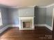 Elegant living room with hardwood floors, a decorative fireplace, and neutral walls at 603 E Main St, Rock Hill, SC 29730