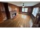 Cozy living room featuring wood paneling, hardwood floors, and a brick fireplace at 603 E Main St, Rock Hill, SC 29730