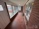 Enclosed sunroom with tile floors, brick walls, and multiple windows, offering plenty of natural light at 603 E Main St, Rock Hill, SC 29730
