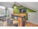Custom bar area featuring a rustic wood countertop and a flat-screen television for entertaining at 8150 Malibu Pointe Ln, Denver, NC 28037
