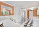 Spacious bathroom with freestanding tub, glass shower, black & white tile floors and luxury fixtures at 8150 Malibu Pointe Ln, Denver, NC 28037