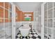 Bright bathroom with clawfoot tub and glass shower, black and white checkered floors, and copper fixtures at 8150 Malibu Pointe Ln, Denver, NC 28037