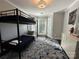 This bedroom features a stylish bunk bed, light gray walls, and a bay window offering natural light at 8150 Malibu Pointe Ln, Denver, NC 28037