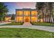 This stately home features a well-manicured lawn and classic design with double-story columns and balconies at 8150 Malibu Pointe Ln, Denver, NC 28037