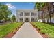 This stunning two-story home boasts manicured landscaping and a grand entrance with stately columns at 8150 Malibu Pointe Ln, Denver, NC 28037