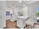 Spacious kitchen with white cabinetry, large island, and breakfast bar seating at 8150 Malibu Pointe Ln, Denver, NC 28037