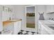 Well-lit laundry room with a sink, counter space, and a window overlooking the lush outdoors at 8150 Malibu Pointe Ln, Denver, NC 28037