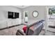 Comfortable living room featuring a large flat-screen television, modern decor, and ample natural light at 8150 Malibu Pointe Ln, Denver, NC 28037