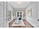 Well-lit home office featuring hardwood floors, large windows, and a modern workspace with stylish decor at 8150 Malibu Pointe Ln, Denver, NC 28037