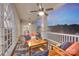 Enjoy the outdoors on this beautiful patio featuring cozy seating, ceiling fans, and picturesque lake views at 8150 Malibu Pointe Ln, Denver, NC 28037
