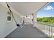 Relaxing covered porch with hammocks and rocking chairs, overlooking the serene lake and trees at 8150 Malibu Pointe Ln, Denver, NC 28037