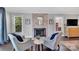 Cozy sitting area with brick fireplace, windows, and comfortable seating at 8150 Malibu Pointe Ln, Denver, NC 28037