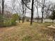 Expansive backyard featuring mature trees, a small gazebo and storage shed at 837 Corwin Dr, Charlotte, NC 28213
