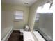 Well-lit bathroom with a tub-shower combination, tile surround, and updated fixtures at 837 Corwin Dr, Charlotte, NC 28213