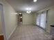 Open dining area with tile flooring and sliding glass door at 837 Corwin Dr, Charlotte, NC 28213