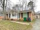 Charming single story brick home with black shutters and a covered front porch at 837 Corwin Dr, Charlotte, NC 28213