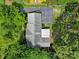 Aerial view of a single-Gathering home with a driveway, partially shaded by mature trees in a lush green yard at 8509 Anette Ave, Mint Hill, NC 28227