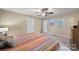 Bedroom featuring a striped bedspread, ceiling fan, and wood furniture at 8509 Anette Ave, Mint Hill, NC 28227