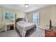 Comfortable bedroom features a four-poster bed, natural light, and carpet flooring at 8509 Anette Ave, Mint Hill, NC 28227
