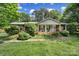 Charming one-story home featuring a brick facade, manicured lawn, and inviting front porch at 8509 Anette Ave, Mint Hill, NC 28227