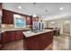 Kitchen featuring a center island with granite countertops, stainless steel appliances, and wood floors at 8509 Anette Ave, Mint Hill, NC 28227
