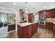 Modern kitchen features a center island, stainless steel appliances, and hardwood floors at 8509 Anette Ave, Mint Hill, NC 28227