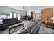Spacious living room featuring exposed brick accents, comfortable leather seating, and ample natural light at 8509 Anette Ave, Mint Hill, NC 28227