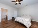 Bright bedroom with hardwood flooring, ceiling fan, and ensuite bathroom access at 864 Ledgestone Ct, Fort Mill, SC 29708