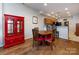 Cozy dining area showcases hardwood floors, a red cabinet, and seamless flow to the kitchen at 864 Ledgestone Ct, Fort Mill, SC 29708