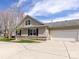 Beautiful home featuring attached two-car garage, double-hung windows and well-maintained lawn at 864 Ledgestone Ct, Fort Mill, SC 29708